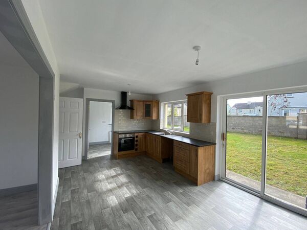 The property has a large kitchen with double doors leading to the garden.
