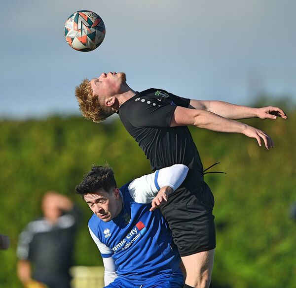 Moore United's James Byrne climbs highest in his efforts to win possession ahead of Manulla FC's Lorcan Conroy during Sunday afternoon's Connacht Cup encounter at Moore. Moore United's James Byrne climbs highest in his efforts to win possession ahead of Manulla FC's Lorcan Conroy during Sunday afternoon's Connacht Cup encounter at Moore.