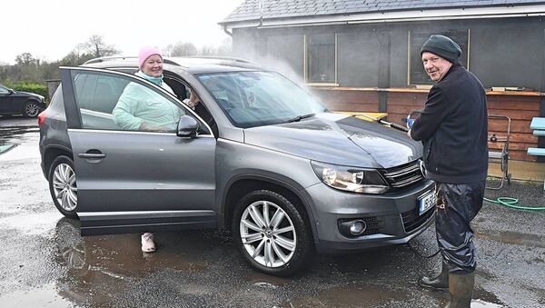 Catherine Gaffey has her car washed by Paddy Connaughton at a car wash in Knockcroghery village as a fundraiser for St. Dominic’s GAA Club. Pic. Gerard O’Loughlin