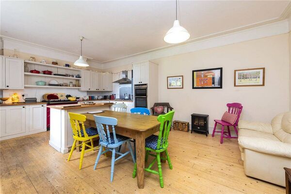 The kitchen / breakfast room is toward the back of the house and is an inviting space featuring an island and a Rayburn cooker. 
