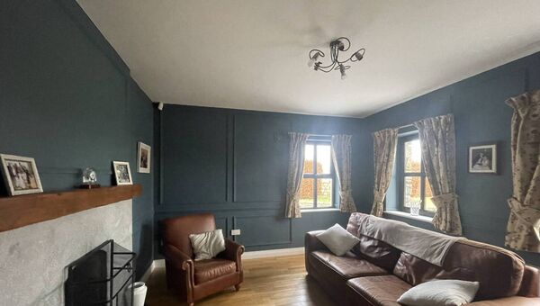The sitting room has an open fire and plenty of natural light.