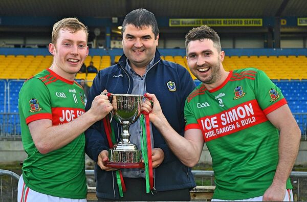 St. Michael's joint-captains, Fiachra Henry and Brian Reynolds, receive the Junior A Cup from Roscommon GAA Chairperson, Brian Carroll. Picture: Gerard O'Loughlin