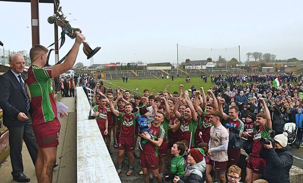 Castlerea St. Kevin's intermediate football captain, Michael Conroy, lifts the Gene Byrne Cup in front of his team-mates after the West Roscommon club were crowned Connacht champions at the end of November. Picture: Gerard O'Loughlin