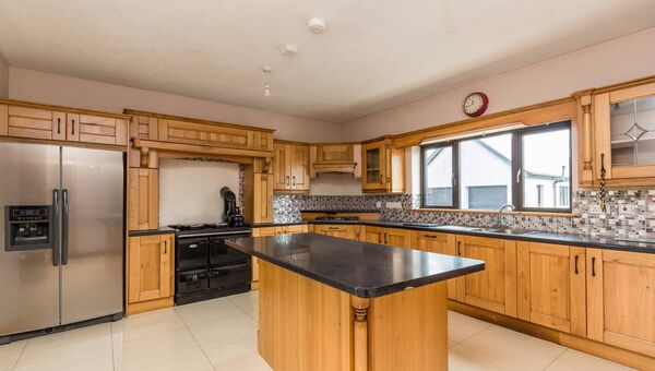 The large kitchen has solid wood units. 