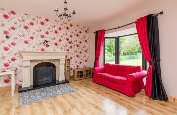 The sitting room features an open fire place and marble surround. 