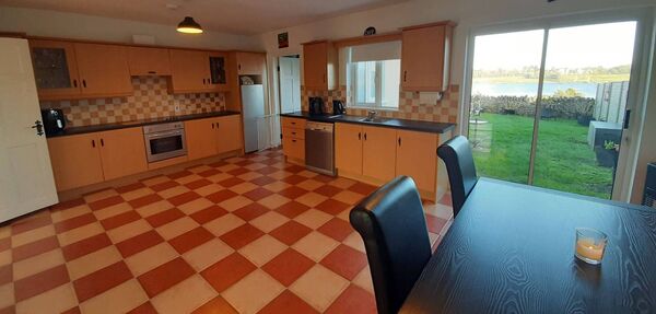 The large kitchen/dining area has double doors leading to the garden.