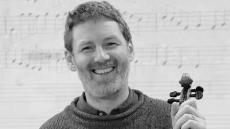 Traditional Irish music students holding Ceol ó Chroí concert