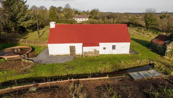 There are two very large gardens either side of the driveway and an outhouse.