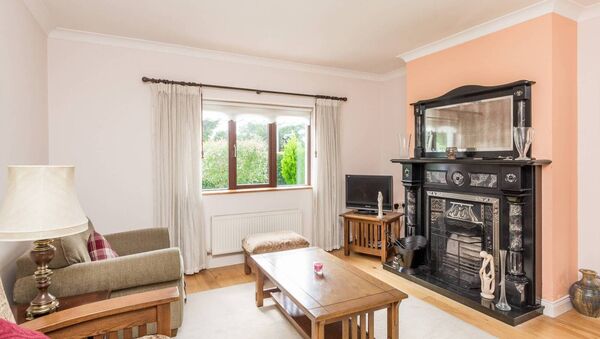 The sitting room has a solid fuel fire place.
