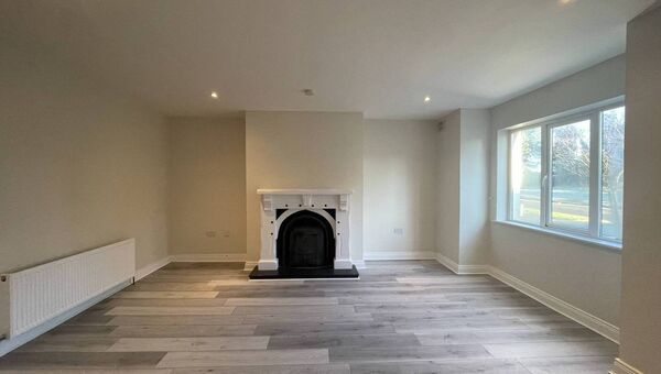 The sitting room is full of light and has an open fireplace. The sitting room is full of light and has an open fireplace.