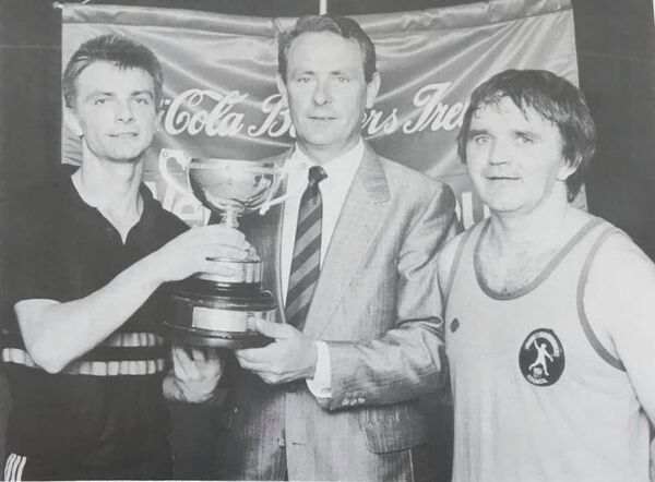 BLAST FROM THE PAST: Mickey Walsh, far right, after one of his epic battles with the late Michael 'Ducksy' Walsh, left. Presenting the trophy is Coca-Cola Ltd Marketing Director, Jim Whelan. 