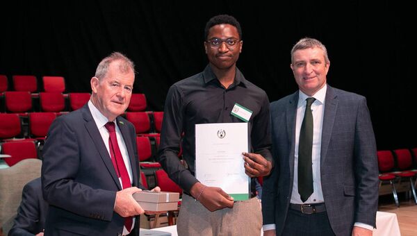 Sponsor JP McManus and Niall Collins, Minister of State at the Department of Further and Higher Education, Research, Innovation and Science presenting an All-Ireland Scholarship Award to Josh Oyiki, Athlone Community College.