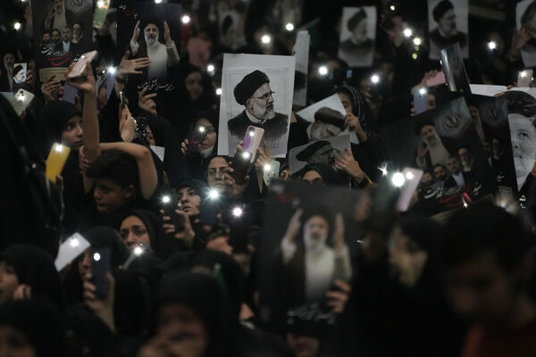 Mourners hold up a posters of the late Iranian President Ebrahim Raisi at the mam Khomeini Grand Mosque in Tehran, Iran, Tuesday, May 21, 2024 during a funeral ceremony for him and his companions who were killed in a helicopter crash on Sunday in a mountainous region of the country's northwest. Mourners in black began gathering Tuesday for days of funerals and processions for Iran's late president, foreign minister and others killed in a helicopter crash, a government-led series of ceremonies aimed at both honoring the dead and projecting strength in an unsettled Middle East. (AP Photo/Vahid Salemi) Mourners hold up a posters of the late Iranian President Ebrahim Raisi at the mam Khomeini Grand Mosque in Tehran, Iran, Tuesday, May 21, 2024 during a funeral ceremony for him and his companions who were killed in a helicopter crash on Sunday in a mountainous region of the country's northwest. Mourners in black began gathering Tuesday for days of funerals and processions for Iran's late president, foreign minister and others killed in a helicopter crash, a government-led series of ceremonies aimed at both honoring the dead and projecting strength in an unsettled Middle East. (AP Photo/Vahid Salemi)