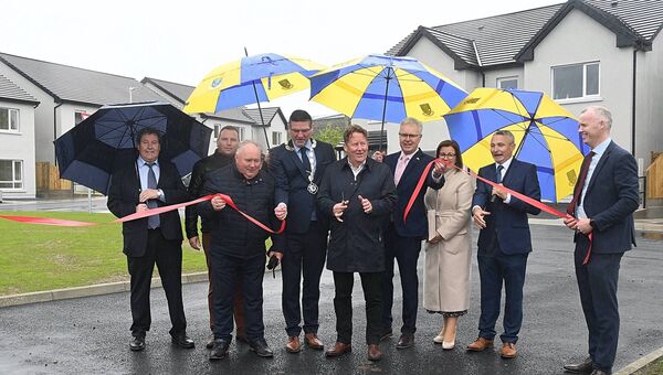 Housing Minister Darragh O'Brien cuts the tape at the opening of a new housing project in Monksland. Pic. Gerard O'Loughlin