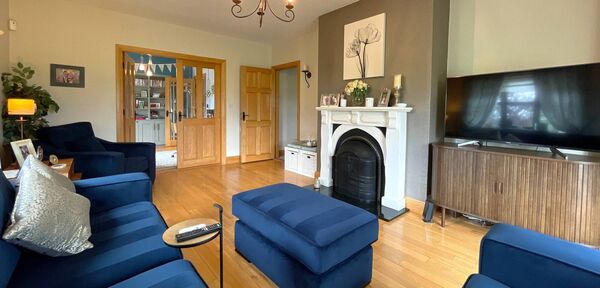 The sitting room has double doors leading to the kitchen.