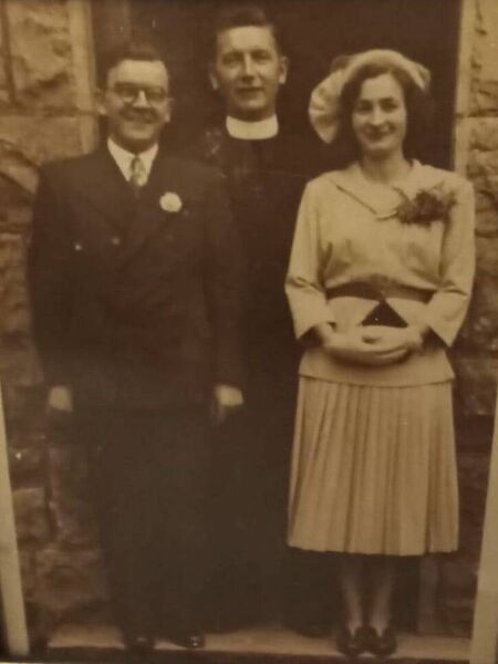 Phil and Mae pictured on their wedding day with Fr. John Kelly. Phil and Mae pictured on their wedding day with Fr. John Kelly.