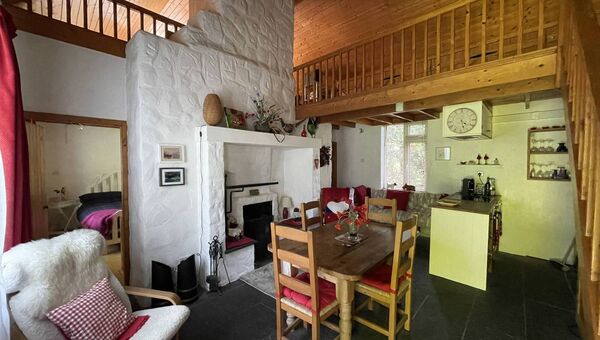 The cosy living/dinging space with high ceilings and balcony style landing. The cosy living/dinging space with high ceilings and balcony style landing.