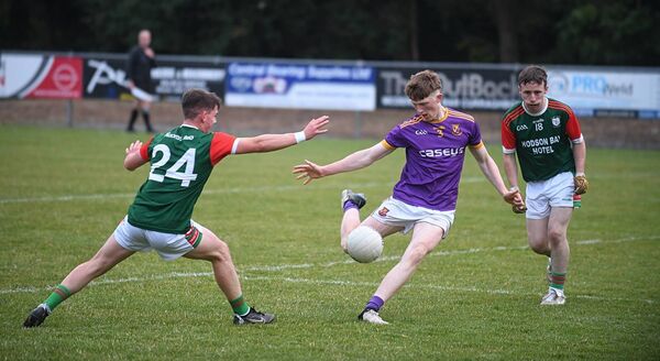 Roscommon Gaels defender James Connolly takes a shot at goal as St. Brigid's duo, Robbie Dolan and Ciarán Quinn, await developments during Friday evening's O'Rourke Cup final at Kiltoom. Picture: Gerard O'Loughlin Roscommon Gaels defender James Connolly takes a shot at goal as St. Brigid's duo, Robbie Dolan and Ciarán Quinn, await developments during Friday evening's O'Rourke Cup final at Kiltoom. Picture: Gerard O'Loughlin