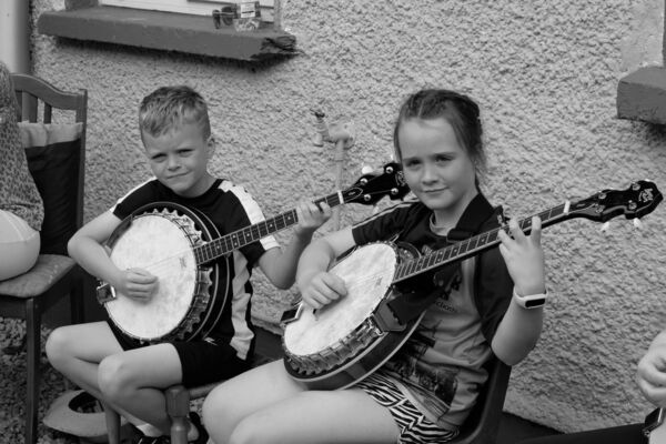 Sean Monaghan and Sophie McMorrow playing the banjo as they enjoyed the O'Carolan Harp Festival and Summer School held in Keadue last week. Picture: David Knight