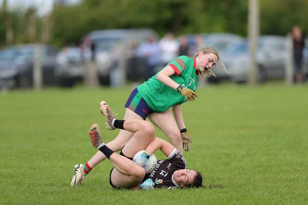 Éire Óg full-forward, Rebecca Finan, is grounded by the challenge of St. Brigid's full-back, Keeley Sammon, during Monday's championship match in Loughglynn. Picture: Bernie O'Farrell