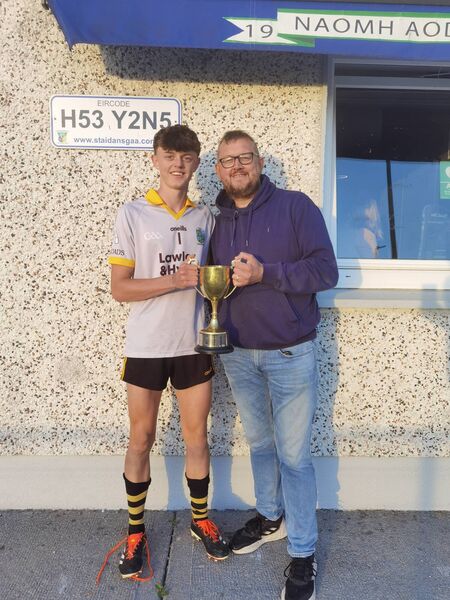 Four Roads U-20 goalkeeper Oisín Finneran with his proud father Ollie after Four Roads won the U-20 hurling championship with a 1-21 to 2-16 victory against Athleague/Tremane/Oran in Ballyforan recently.