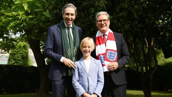 Dublin boy treated for rare illness presents Harris and Starmer with football shirts