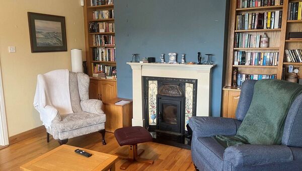The cosy sitting room with a stove inset. The cosy sitting room with a stove inset.
