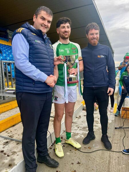 St. Barry's captain Eoghan Diffley accepts the Junior A Cup from Roscommon GAA Chairperson, Brian Carroll, and Padraic King, King and Moffatt, Junior A football championship sponsors. St. Barry's captain Eoghan Diffley accepts the Junior A Cup from Roscommon GAA Chairperson, Brian Carroll, and Padraic King, King and Moffatt, Junior A football championship sponsors.