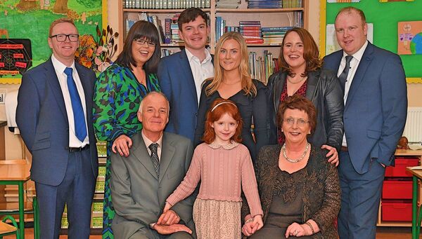 Mary O’Brien-Healy, on her last day at Ballintleva NS after 35 years of teaching, pictured with family members, including her husband James and granddaughter Éala Monaghan. Back row, from left: Padraig Judge, Méabh Healy, John Healy, Caroline Keaveny, Catherine Healy and Chris Monaghan. Pic. Gerard O’Loughlin