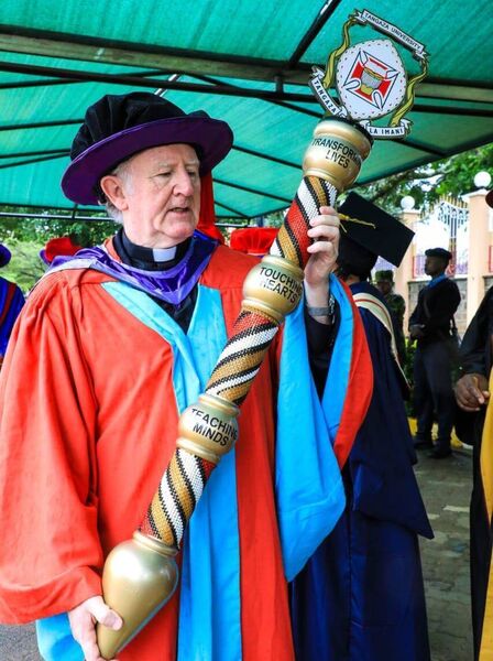 Fr Padraig Devine carrying the University Mace during the graduation ceremony.