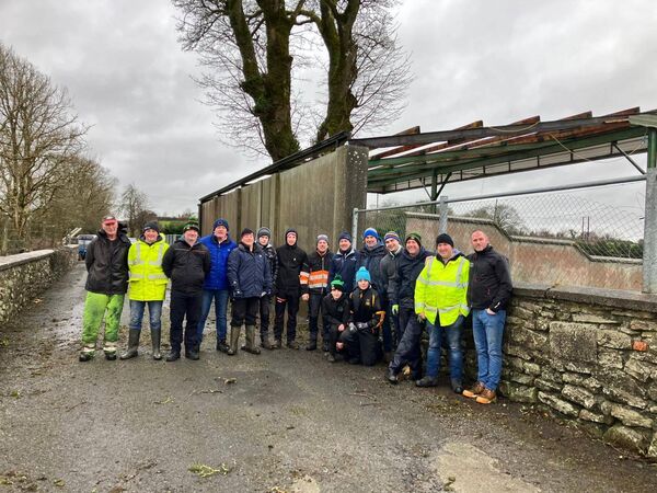 The volunteers who cleared away the roof sheeting and debris at Michael Glaveys GAA
                         club grounds.
