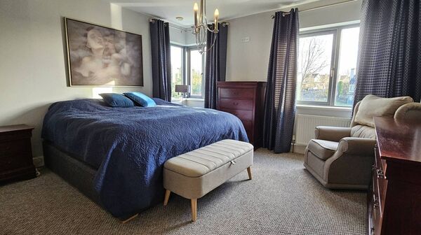 The master bedroom is a large south facing double room with feature corner window and en-suite.