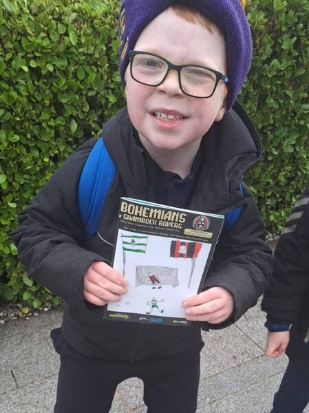 Conor Concannon with the match day programme containing his winning picture.
