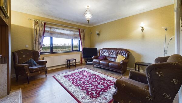 The home features a large sitting room with elegant coving. The home features a large sitting room with elegant coving.