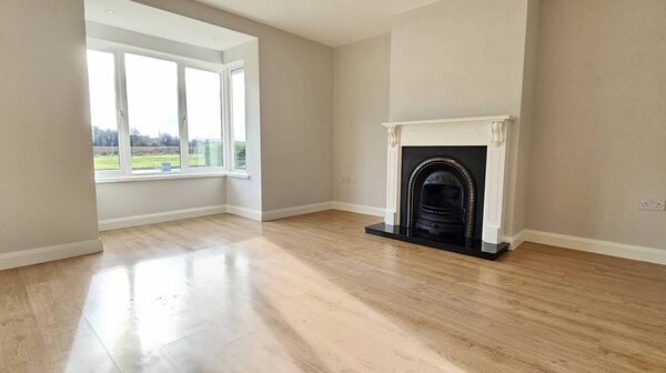 The spacious living room has an open fire and bay window. The spacious living room has an open fire and bay window.