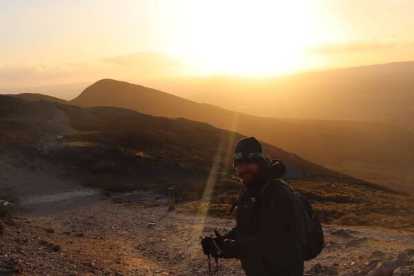 Niall Flynn pictured enjoying the view as the sun sets on Croagh Patrick.