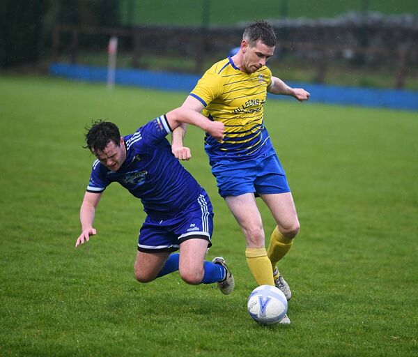 St. John's Athletic's Karl Feerick and Skyvalley Rovers' John Feehily try and win possession during Friday evening's Challenge Cup semi-final at the RDFL Grounds, Lecarrow. Pictures: Gerard O'Loughlin