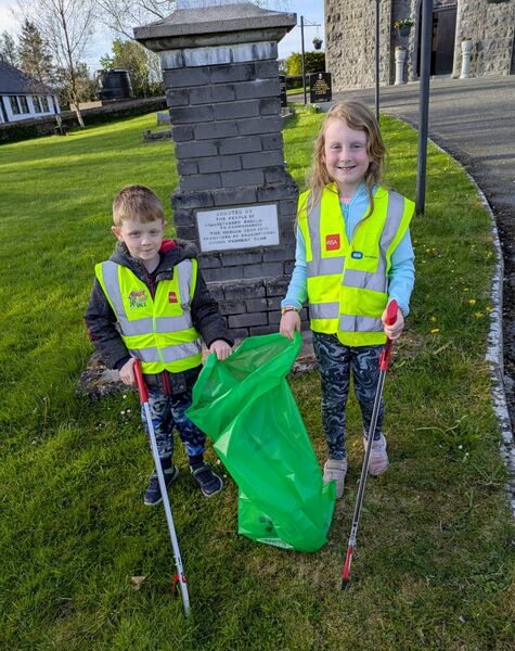 Elisa Egan with Jackson Fleming cleaning up around the church grounds during a Ballintubber Tidy Towns Spring Clean in Ballintubber last week. Pic: Liam Reynolds 