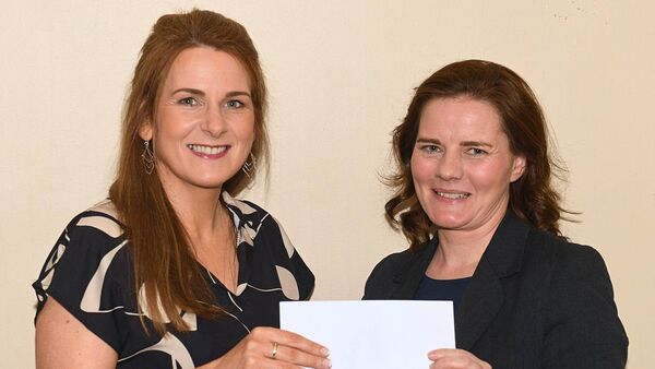 Roscommon Ploughing Association treasurer Martina Beirne accepting a sponsorship cheque from Majella McDermott on behalf of AIB Roscommon. Pic: Gerard O'Loughlin