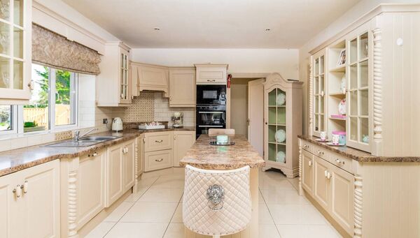 The cream kitchen has ample storage and modern conveniences.