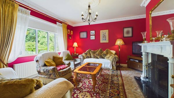 The cosy sitting room has an open fire.