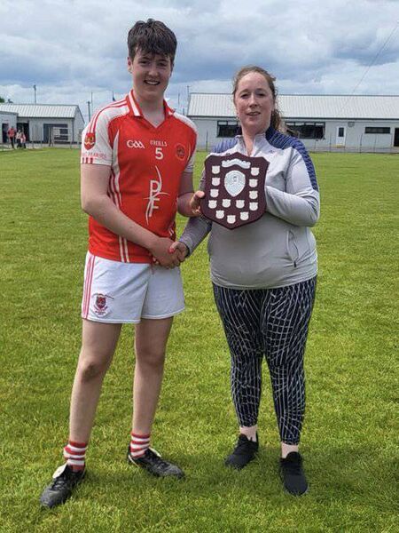 Pádraig Pearses captain Donnacha Whyte accepts the shield from Roscommon Minor Board Fixtures Secretary, Paula Clogher. Picture: Roscommon GAA