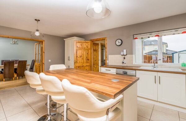 Abundant natural light, sleek finishes, and a well-planned layout make this kitchen space perfect for relaxed family meals.