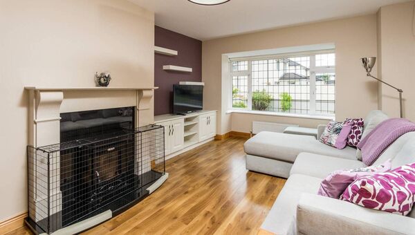 The generously proportioned living room offers an elegant retreat for relaxation or hosting guests.