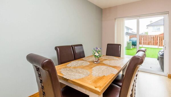 The dining area has double doors leading to the garden.