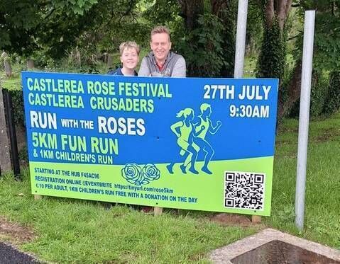 Peter Turner, Castlerea Crusader's coach and Run with the Roses run director with Julian, club member, after erecting a sign designed by Niamh Donlon, graphic designer for the Run with the Roses 5km, happening on Sunday, July 27th at 9.30 a.m. starting from The Hub in Castlerea.