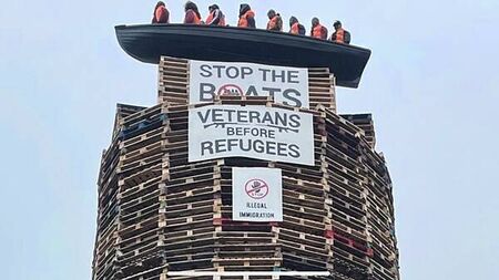 Calls for removal of migrant effigies in boat placed on loyalist bonfire in NI