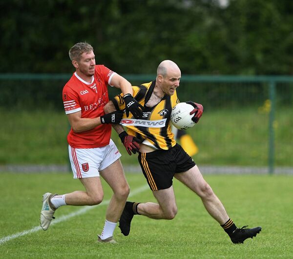 Ballinameen’s Dylan Casey gets a tight grip of Gerard Collins of Strokestown during the Tansey Cup (Division 3) Final at Strokestown on Sundat. Pic: Ger O’Loughlin. 