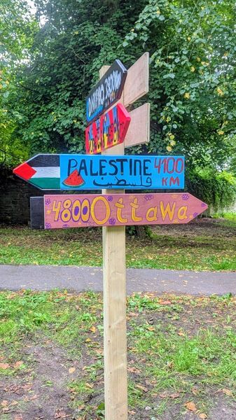 How the signpost stood in The Demesne before the Palestine sign was stolen.
