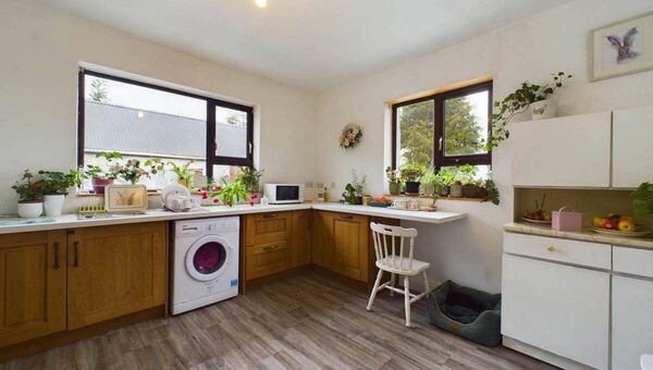 The kitchen, equipped with state-of-the-art appliances and premium finishes, serves as the heart of the home.